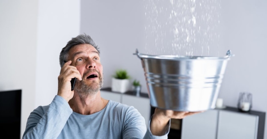 man dealing with roof leak